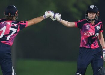 Kathryn and Sarah Bryce touch gloves