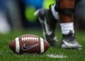 A football sits on turf