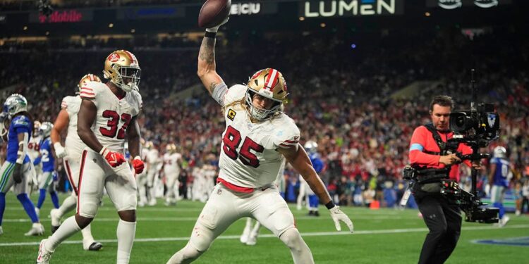 George Kittle spikes the ball