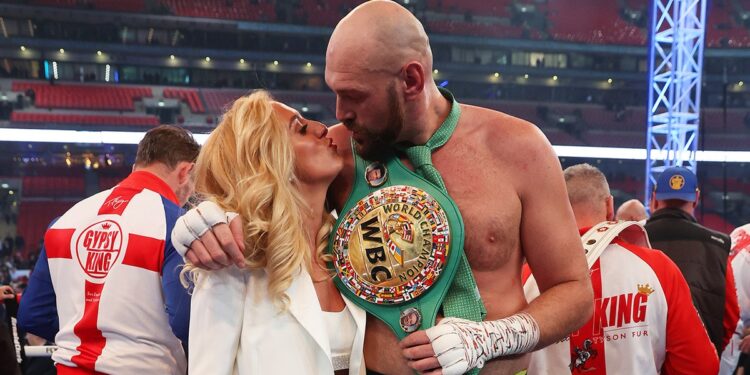 Tyson and Paris Fury kiss in boxing ring