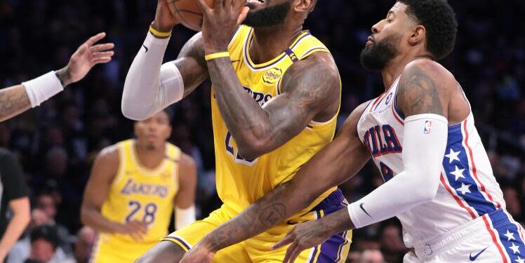 Los Angeles, California November 8, 2024-Lakers LeBron James drives on 76ers Paul George.