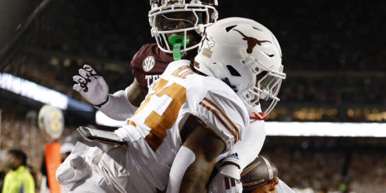 COLLEGE STATION, TEXAS - NOVEMBER 30: Jaydon Blue #23 of the Texas Longhorns catches a pass for a touchdown against Bryce Anderson #1 of the Texas A&M Aggies during the second quarter at Kyle Field on November 30, 2024 in College Station, Texas. (Photo by Tim Warner/Getty Images)