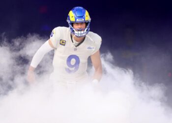 Rams quarterback Matthew Stafford runs through smoke during introductions before a home game.