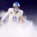 Rams quarterback Matthew Stafford runs through smoke during introductions before a home game.