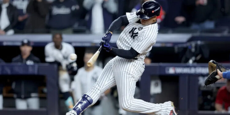 Oct 29, 2024; New York, New York, USA; New York Yankees outfielder Juan Soto (22) doubles during the eighth inning against the Los Angeles Dodgers in game four of the 2024 MLB World Series at Yankee Stadium. Mandatory Credit: Brad Penner-Imagn Images