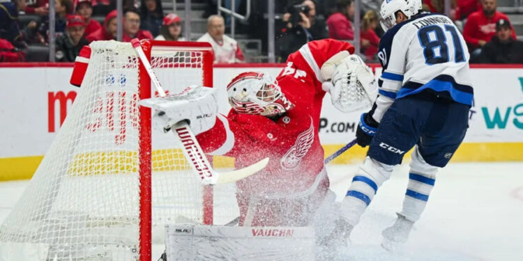 Oct 30, 2024; Detroit, Michigan, USA; Winnipeg Jets left wing Kyle Connor (81) scores a goal as Detroit Red Wings goaltender Alex Lyon (34) tends the net during the first period at Little Caesars Arena. Mandatory Credit: Tim Fuller-Imagn Images