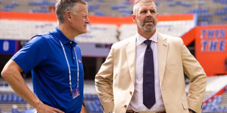 Sep 14, 2024; Gainesville, Florida, USA; Florida Gators athletic director Scott Stricklin (left) and head coach Billy Napier talk before a game against the Texas A&M Aggies at Ben Hill Griffin Stadium. Mandatory Credit: Matt Pendleton-Imagn Images