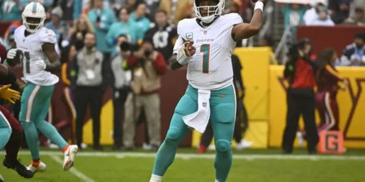 Dec 3, 2023; Landover, Maryland, USA; Miami Dolphins quarterback Tua Tagovailoa (1) drops back to pass against the Washington Commanders during the first half at FedExField. credits: Brad Mills-USA TODAY Sports