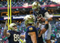 Notre Dame Fighting Irish quarterback Riley Leonard (13) celebrates with teammates after a touchdown against the Georgia Tech Yellow Jackets in the second quarter at Mercedes-Benz Stadium. Mandatory Credit: Brett Davis-Imagn Images