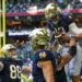 Notre Dame Fighting Irish quarterback Riley Leonard (13) celebrates with teammates after a touchdown against the Georgia Tech Yellow Jackets in the second quarter at Mercedes-Benz Stadium. Mandatory Credit: Brett Davis-Imagn Images