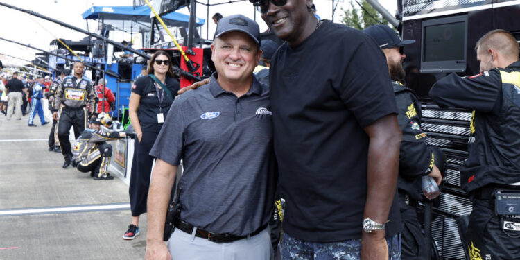 Bob Jenkins, owner of Front Row Motorsports and Co-Owner Michael Jordan, of 23XI Racing, pose before a NASCAR Cup Series auto race at Talladega Superspeedway, Sunday, Oct. 6, 2024, in Talladega, Ala. (AP Photo/ Butch Dill)