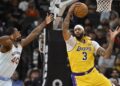 Los Angeles Lakers' Anthony Davis (3) grabs the rebound ahead of San Antonio Spurs' Harrison Barnes during the first half of an NBA basketball game, Wednesday, Nov. 27, 2024, in San Antonio. (AP Photo/Darren Abate)