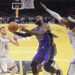 Los Angeles Lakers forward LeBron James, center, shoots as Oklahoma City Thunder center Isaiah Hartenstein, left, and guard Shai Gilgeous-Alexander defend during the first half of an Emirates NBA Cup basketball game, Friday, Nov. 29, 2024, in Los Angeles. (AP Photo/Mark J. Terrill)