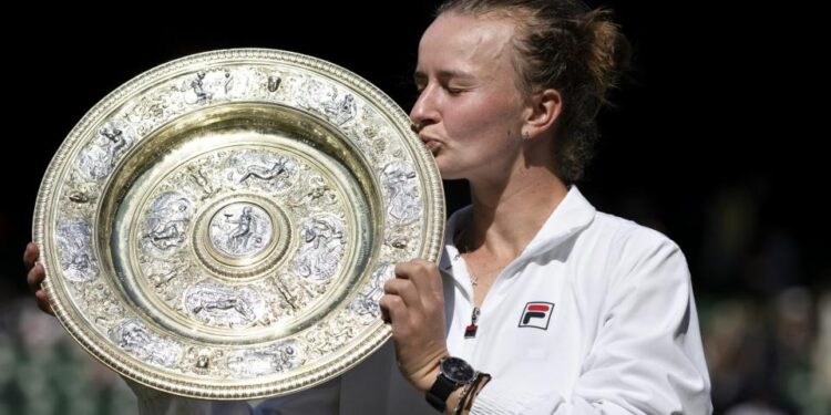 Barbora Krejcikova (CZE) kisses the trophy after winning her Ladies's Singles Final against Jasmine Paolini (ITA) during day thirteen of The Championships Wimbledon