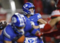 SALT LAKE CITY, UT - NOVEMBER 9:  Jake Retzlaff #12 of the Brigham Young Cougars throws a pass under pressure from the Utah Utes during the first half of their game at Rice-Eccles Stadium on November 9, 2024 in Salt Lake City, Utah.(Photo by Chris Gardner/Getty Images)