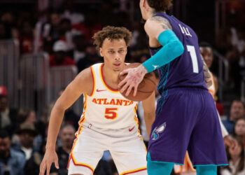 Oct 25, 2024; Atlanta, Georgia, USA; Atlanta Hawks guard Dyson Daniels (5) plays defense against Charlotte Hornets guard LaMelo Ball (1) during the fourth quarter at State Farm Arena. Mandatory Credit: Jordan Godfree-Imagn Images