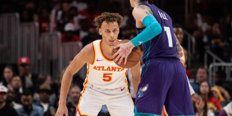 Oct 25, 2024; Atlanta, Georgia, USA; Atlanta Hawks guard Dyson Daniels (5) plays defense against Charlotte Hornets guard LaMelo Ball (1) during the fourth quarter at State Farm Arena. Mandatory Credit: Jordan Godfree-Imagn Images