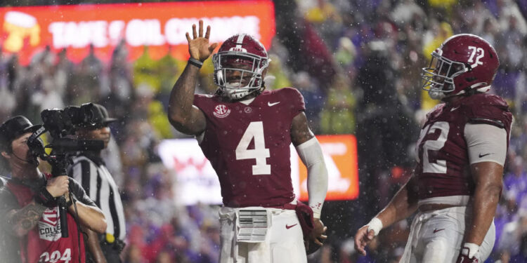 Alabama quarterback Jalen Milroe (4) celebrates his touchdown carry in the first half an NCAA college football game against LSU in Baton Rouge, La., Saturday, Nov. 9, 2024. (AP Photo/Gerald Herbert)