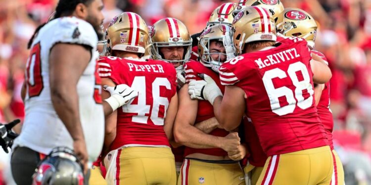 <span>Jake Moody celebrates with his San Francisco 49ers teammates after scoring the game-winning field goal against the Tampa Bay Buccaneers.</span><span>Photograph: Julio Aguilar/Getty Images</span>