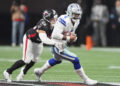 Atlanta Falcons linebacker Kaden Elliss (55) tackles Dallas Cowboys quarterback Dak Prescott (4) during the second half of an NFL football game, Sunday, Nov. 3, 2024, in Atlanta. (AP Photo/ Brynn Anderson)