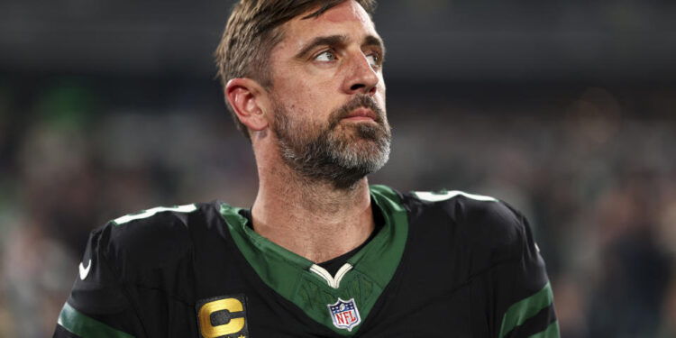 EAST RUTHERFORD, NEW JERSEY - OCTOBER 31: Aaron Rodgers #8 of the New York Jets stands on the sidelines during the national anthem prior to an NFL football game against the Houston Texans, at MetLife Stadium on October 31, 2024 in East Rutherford, New Jersey. (Photo by Kevin Sabitus/Getty Images)