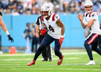 Nov 3, 2024; Nashville, Tennessee, USA;  New England Patriots running back Antonio Gibson (4) runs the ball against the Tennessee Titans during the second half at Nissan Stadium. Mandatory Credit: Steve Roberts-Imagn Images