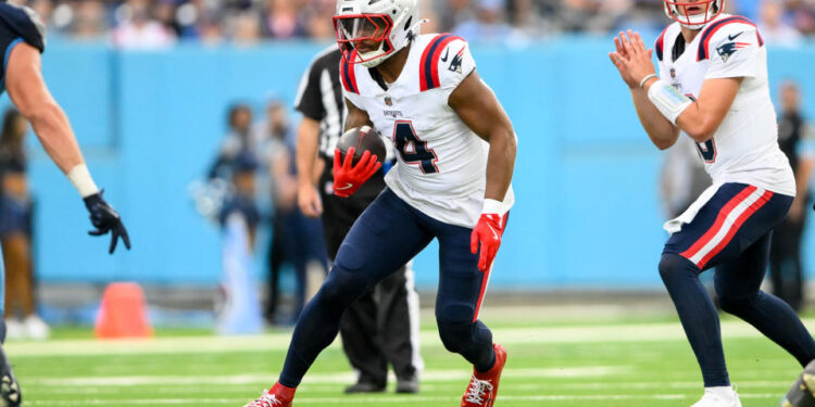 Nov 3, 2024; Nashville, Tennessee, USA;  New England Patriots running back Antonio Gibson (4) runs the ball against the Tennessee Titans during the second half at Nissan Stadium. Mandatory Credit: Steve Roberts-Imagn Images