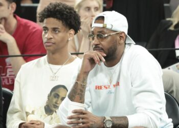 PARIS, FRANCE - AUGUST 8: Carmelo Anthony and his son Kiyan Anthony (left) attend the Men's Basketball semifinal game between Team France and Team Germany on day thirteen of the Olympic Games Paris 2024 at Bercy Arena on August 8, 2024 in Paris, France. (Photo by Jean Catuffe/Getty Images)