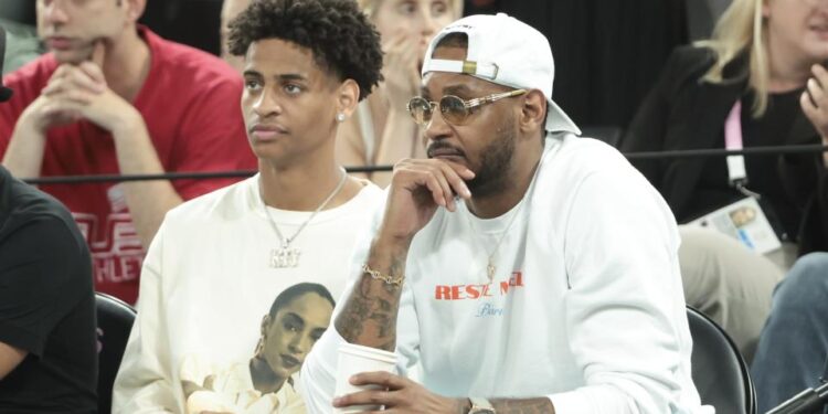 PARIS, FRANCE - AUGUST 8: Carmelo Anthony and his son Kiyan Anthony (left) attend the Men's Basketball semifinal game between Team France and Team Germany on day thirteen of the Olympic Games Paris 2024 at Bercy Arena on August 8, 2024 in Paris, France. (Photo by Jean Catuffe/Getty Images)