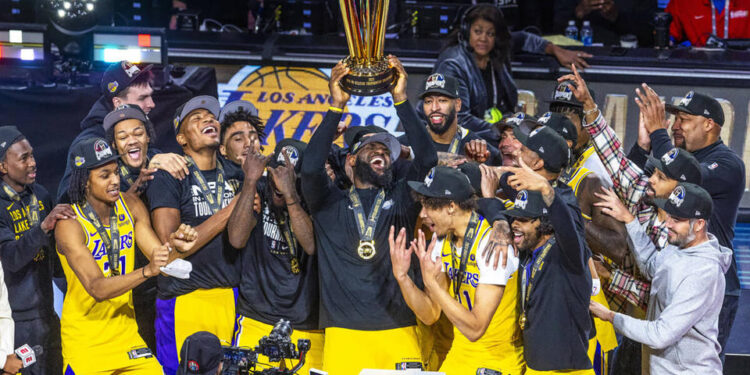 The Los Angeles Lakers' LeBron James holds up the winning trophy along with teammates after defeating the Indiana Pacers in their NBA in-season tournament championship game at T-Mobile Arena on Dec. 9, 2023, in Las Vegas. (L.E. Baskow/Las Vegas Review-Journal/Tribune News Service via Getty Images)