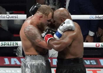 US YouTuber/boxer Jake Paul (L) and US retired pro-boxer Mike Tyson (R) hug at the end of their heavyweight boxing bout at The Pavilion at AT&T Stadium in Arlington, Texas, November 15, 2024. (Photo by TIMOTHY A. CLARY / AFP) (Photo by TIMOTHY A. CLARY/AFP via Getty Images)