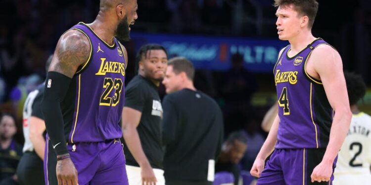 Los Angeles, California November 19, 2024-Lakers LeBron James, left, celebrates Dalton Knecht's three-pointer against the Jazz in the second half at Crypto.com Arena Tuesday. (Wally Skalij/Los Angeles Times)