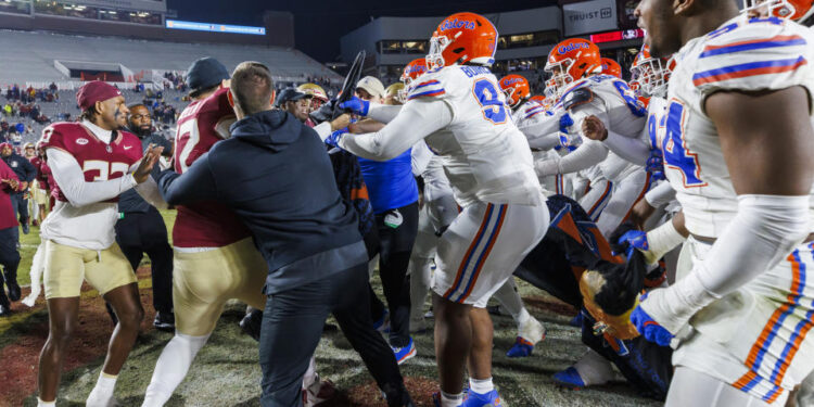 Florida State and Florida players scuffle at midfield after an NCAA college football game Saturday, Nov. 30, 2024, in Tallahassee, Fla. (AP Photo/Colin Hackley)