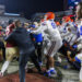 Florida State and Florida players scuffle at midfield after an NCAA college football game Saturday, Nov. 30, 2024, in Tallahassee, Fla. (AP Photo/Colin Hackley)