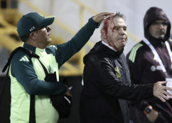 TOPSHOT - Mexico's coach, Javier Aguirre, is helped by an assistant after being injured in the head when he was hit by an object thrown from the bleachers at the end of the National League of CONCACAF quarterfinal first leg match between Honduras and Mexico on November 15, 2024. (Photo by JHONY MAGALLANES/AFP via Getty Images)