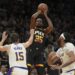 Suns forward Kevin Durant shoots over Lakers guard Austin Reaves and forward Anthony Davis Tuesday in Phoenix.