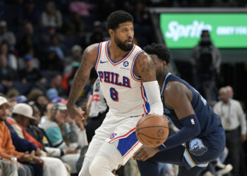 Philadelphia 76ers forward Paul George (8) handles the ball ahead of Memphis Grizzlies forward Jaren Jackson Jr. (13) in the first half of an NBA basketball game Wednesday, Nov. 20, 2024, in Memphis, Tenn. (AP Photo/Brandon Dill)