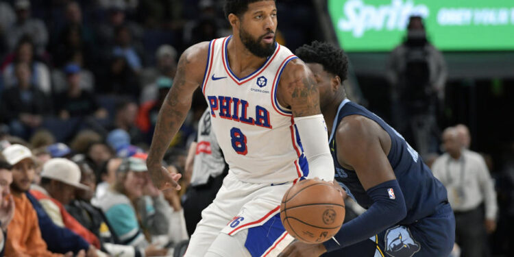 Philadelphia 76ers forward Paul George (8) handles the ball ahead of Memphis Grizzlies forward Jaren Jackson Jr. (13) in the first half of an NBA basketball game Wednesday, Nov. 20, 2024, in Memphis, Tenn. (AP Photo/Brandon Dill)