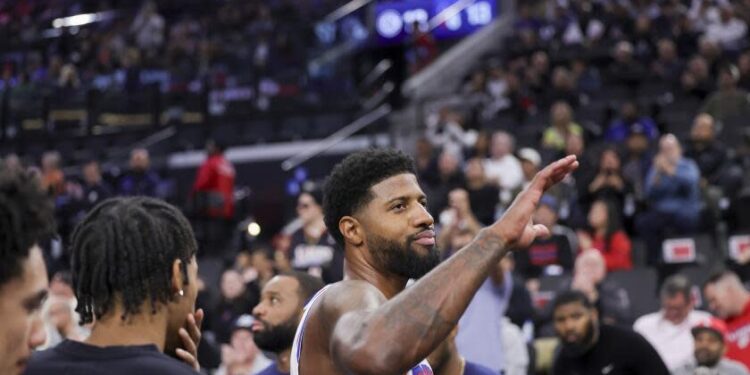 Philadelphia 76ers forward Paul George greets the crowd during the first half of an NBA basketball game, Wednesday against the Los Angeles Clippers, Nov. 6, 2024, in Inglewood, Calif. (AP Photo/Ryan Sun)