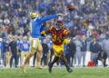 UCLA quarterback Ethan Garbers delivers a pass under pressure from USC defensive end Braylan Shelby at the Rose Bowl.