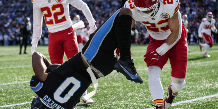 Kansas City Chiefs linebacker Drue Tranquill (23) hits Carolina Panthers tight end Ja'Tavion Sanders (0) during the first half of an NFL football game, Sunday, Nov. 24, 2024, in Charlotte, N.C. Sanders, was taken off the field due to injury after the play. (AP Photo/Rusty Jones)