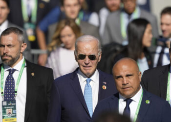 U.S. President Joe Biden arrives late for the group photo during the G20 Summit in Rio de Janeiro, Monday, Nov. 18, 2024. (AP Photo/Eraldo Peres)