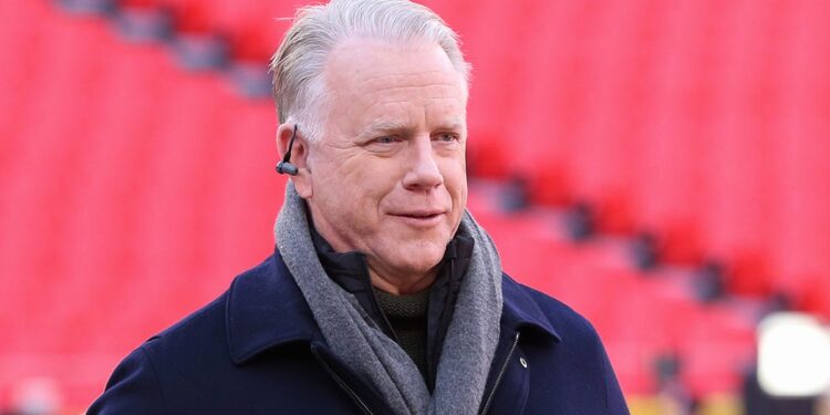 Boomer Esiason stands on the football field