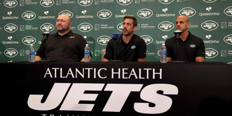 New York Jets general manager Joe Douglas, quarterback Aaron Rodgers and head coach Robert Saleh attend a press conference at Atlantic Health Jets Training Center on April 26, 2023 in Florham Park, New Jersey.