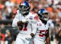 New York Giants linebacker Bobby Okereke and New York Giants linebacker Azeez Ojulari celebrate after a sack during the first quarter against the Cleveland Browns at Huntington Bank Field.