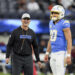 Los Angeles Chargers head coach Jim Harbaugh smiles next to quarterback Justin Herbert (10) before an NFL football game against the Cincinnati Bengals, Sunday, Nov. 17, 2024, in Inglewood, Calif. (AP Photo/Gregory Bull)