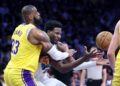 Los Angeles, California November 13, 2024-Lakers LeBron James tries to steal the ball away from Grizzlies Jaren Jackson Jr. in the first half at Crypto.com Arena Wednesday. (Wally Skalij/Los Angeles Times)