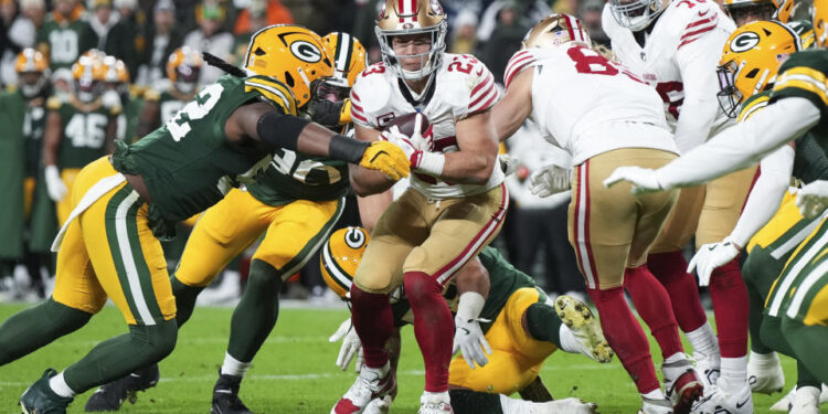 GREEN BAY, WISCONSIN - NOVEMBER 24: Running back Christian McCaffrey #23 of the San Francisco 49ers runs the ball during the first half of an NFL football game against the Green Bay Packers at Lambeau Field on November 24, 2024 in Green Bay, Wisconsin. (Photo by Todd Rosenberg/Getty Images)