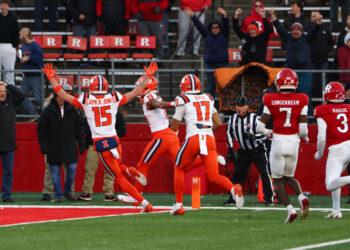 PISCATAWAY, NEW JERSEY - NOVEMBER 23: Pat Bryant #13 of the Illinois Fighting Illini scores a touchdown during the fourth quarter of their game against the Rutgers Scarlet Knights at SHI Stadium on November 23, 2024 in Piscataway, New Jersey. (Photo by Ed Mulholland/Getty Images)