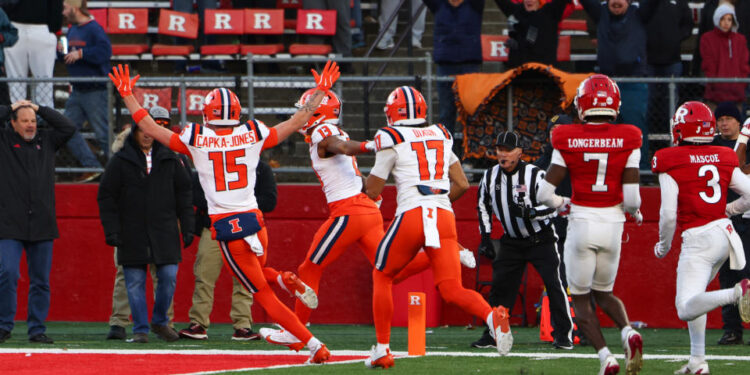 PISCATAWAY, NEW JERSEY - NOVEMBER 23: Pat Bryant #13 of the Illinois Fighting Illini scores a touchdown during the fourth quarter of their game against the Rutgers Scarlet Knights at SHI Stadium on November 23, 2024 in Piscataway, New Jersey. (Photo by Ed Mulholland/Getty Images)